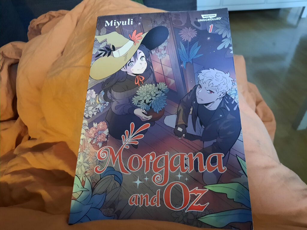 Die Taschenbuchausgabe des Comics "Morgana and Oz" - die eine junge Hexe mit einem breitkrempigen Hexenhut und einen in Leder gekleideten jungen Vampir zeigt.