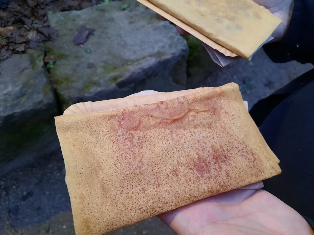 Eine Hand, die einen viereckig gefalteten Crepe hält.