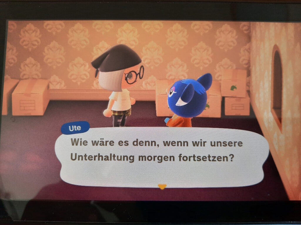 Ein Animal-Crossing-Screenshot, der meine neue Nachbarin Ute umringt von Umzugskartons zeigt. Ihr gegenüber steht meine Figur und sie sagt "Wie wäre es denn, wenn wir unsere Unterhaltung morgen fortsetzen?